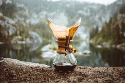 Chemex coffee on a log by the water