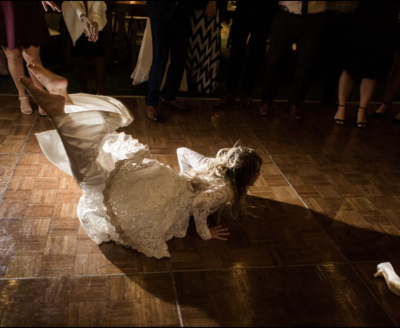 Orange County Wedding Experience - bride doing the worm in her wedding dress during the reception