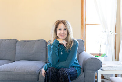 Image of Cyndi sitting on a sofa