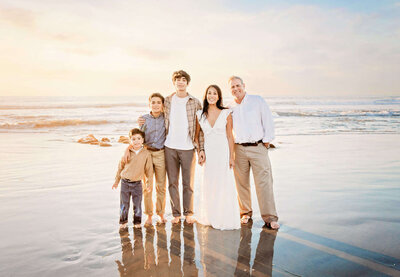 Family pictures during a San Diego senior photography session at the beach