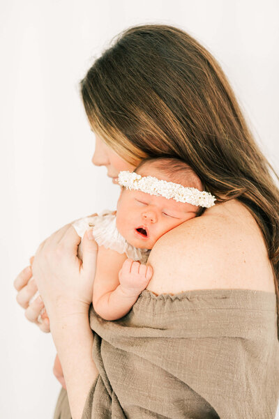 framed newborn photo of baby girl in mothers arm captured by Springfield MO newborn photographer The XO Photography