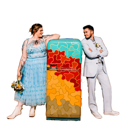 A queer couple stands with artistic mini-fridge in Connecticut on their wedding day