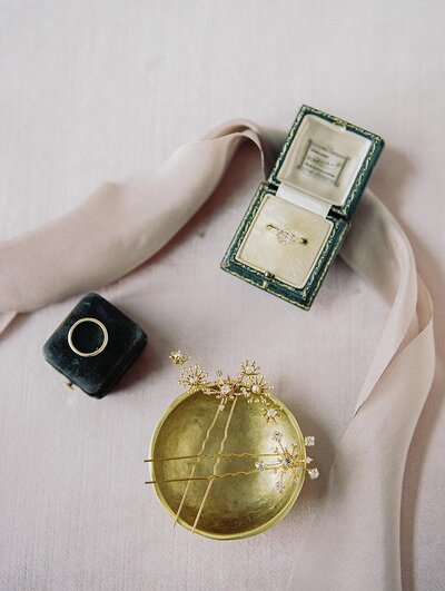 Celestial bridal hair pins and a vintage green ring box holding a princess cut engagement ring