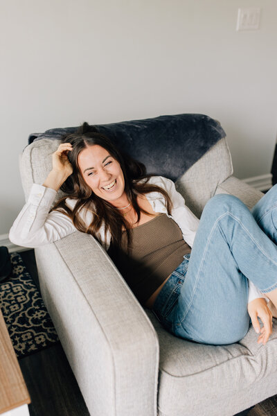 Headshot of Emily, founder of Boss & Buddha, smiling at camera with head tilted to left