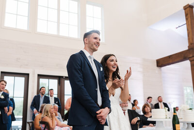 bride and groom laughing at reception