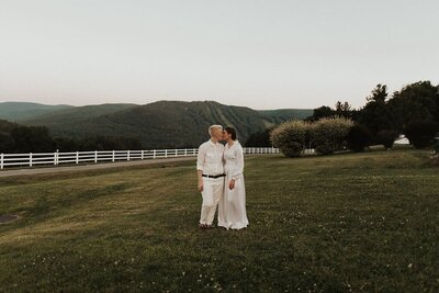 Couple standing in field looking at each other, Unique Melody Events & Design (New England Wedding Planners) were part of this wedding.