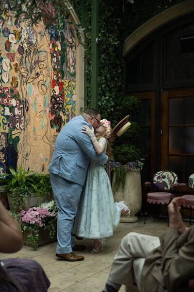 Bride and groom first kiss at the Garden Room St. Regis hotel