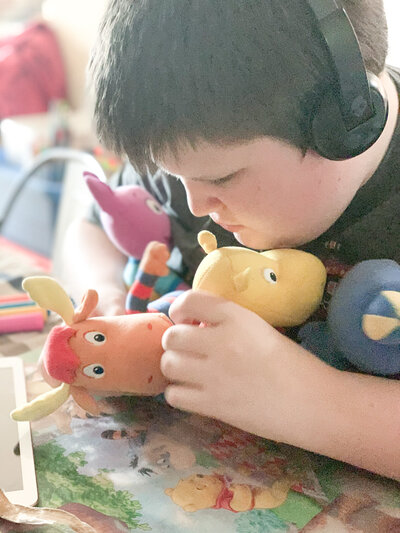 William playing with Backyardigans stuffies