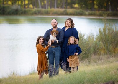 family of four standing together in a field