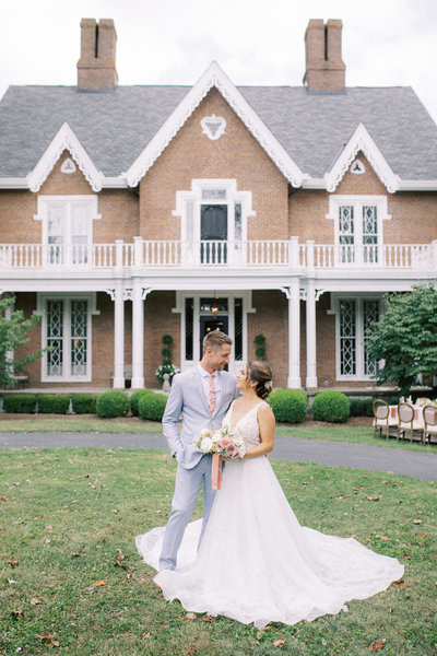 Couple sits on large staircase during an engagement session at Ault Park