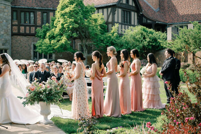 women standing in pink dresses