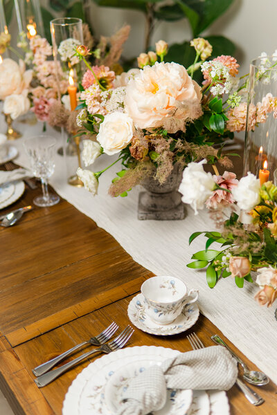 White peony, ranunculus and wax flower wedding centerpiece at Verde Olivo FLoral Studio in Southern California.