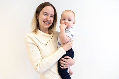 Women holding her baby, smiling