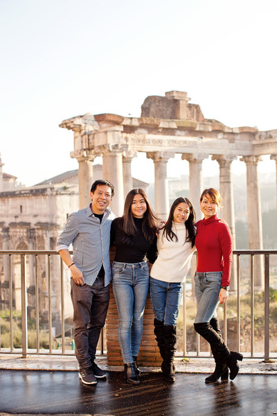 A family of four standing in front of the Roman Forum. Rome Photographer, Taken by Rome Photographer, Tricia Anne Photography.