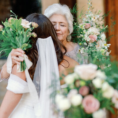 Bride hugging her grandma on her wedding day