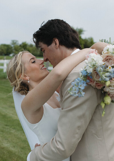 A close up shot of a bride and groom staring lovingly into each other's eyes during their wedding portraits. Captured by a Minnesota Wedding Photographer specializing in intimate, documentary style weddings