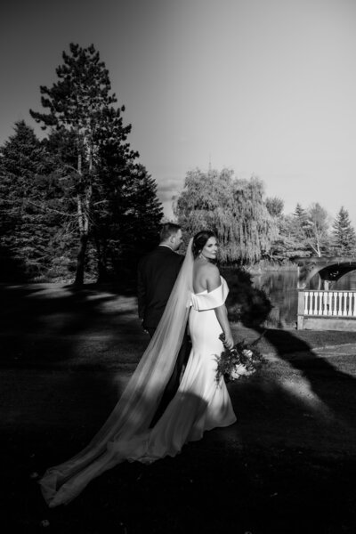 bride groom walking to reception in harsh light