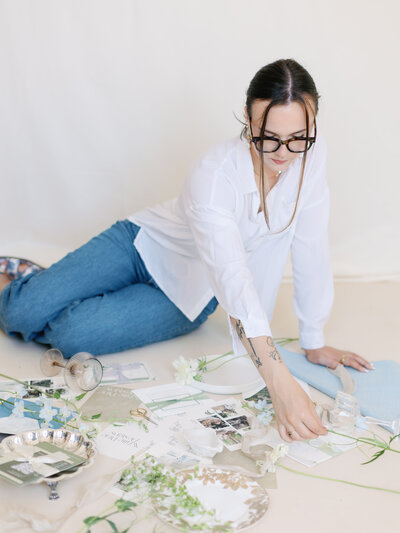 woman leans against a table