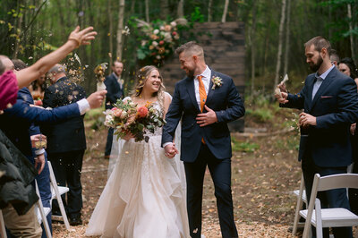 birde and groom have confetti thrown on them after wedding ceremony photo by cait fletcher photography