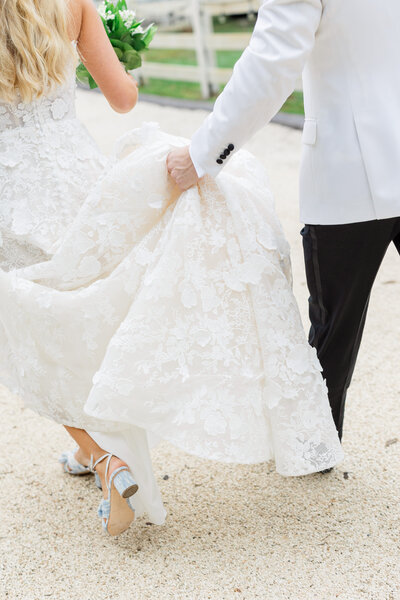 candid black and white photo of bride & groom entering their reception