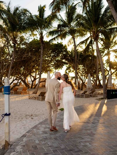two people getting married walking on a beach in the Dominican Republic at Cayo Levantado for a destination elopement