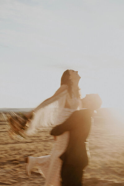 Groom picks up bride