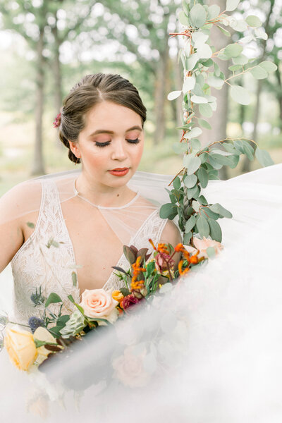 wedding portrait of groom twirling bride in a park