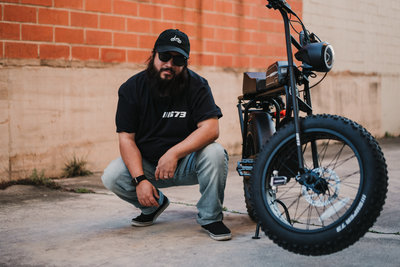 San Antonio Photographer David Castillo posing with his Lithium Cycle Super 73 electric bicycle for instagram @txpunisher