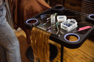 Close-up of professional styling tools, including curling irons, at Intrigue Salon