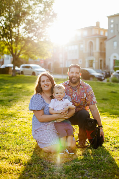 Family of three with golden light behind them in downtown Seattle