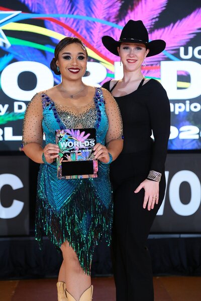 Morgan owner of Curtsy Ballroom winning an award in competition