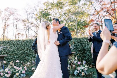 Bride and groom kissing during wedding ceremony