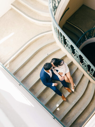 engagement photography of couple sitting on stairwell at pasadena city hall