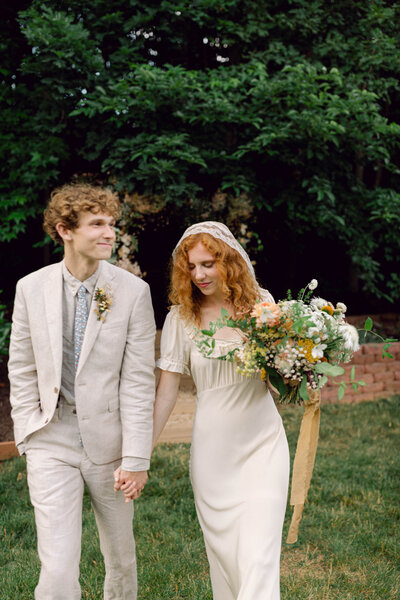 Groom Jon experiences an emotional moment during his intimate backyard wedding in Richmond, Virginia, captured by a film wedding photographer.