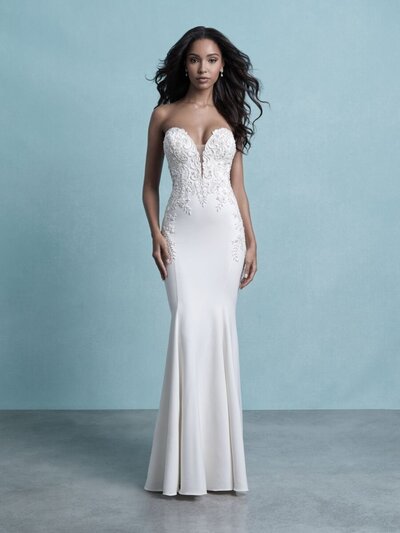 The soft crepe of this strapless sheath gown balances the dramatic effect of its laced back, beadwork and stunning train.