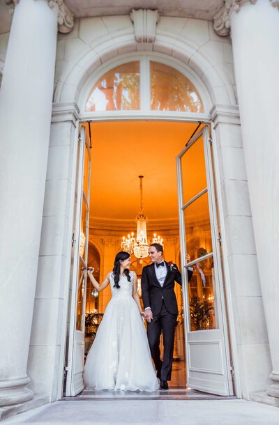 wedding couple coming out of the door from the Meridian House in Washington D.C.