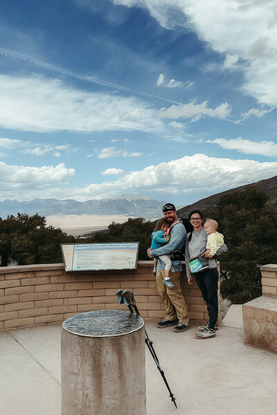 Big Bend elopement photographer captures a tender family moment in the desert mountains of West Texas, with golden light, cacti, and rugged peaks framing the scene.