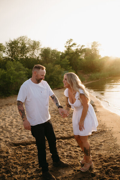 Couples session in field at sunset