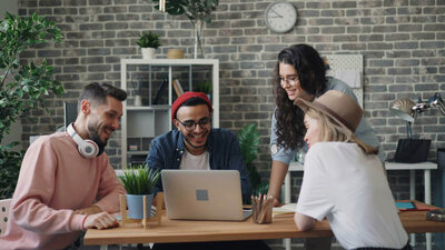 Group of real estate agents siitting at a table with a computer