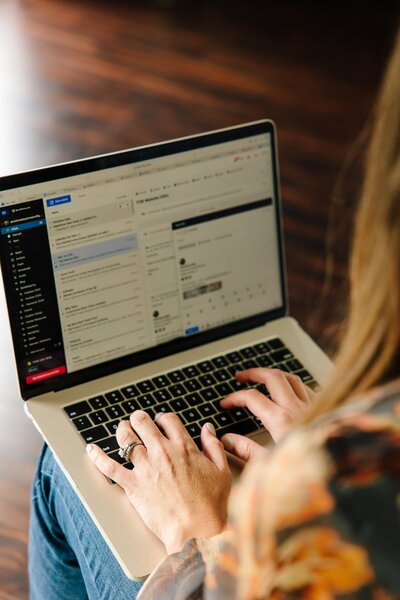 woman sending emails on a laptop