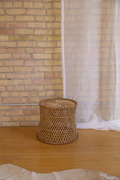 A small round rattan coffee table.