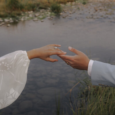 destination elopement photography in isle of skye, hands reaching, bride and groom eloping