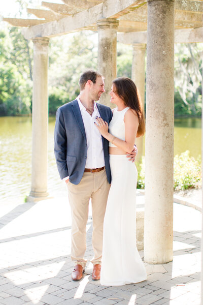 Couple standing on a patio by a river