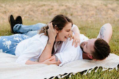 couple laying in a field