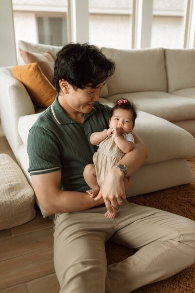 Dad holding a newborn baby