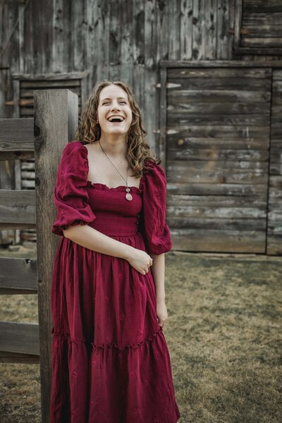 senior girl poses at a barn in carrollton texas