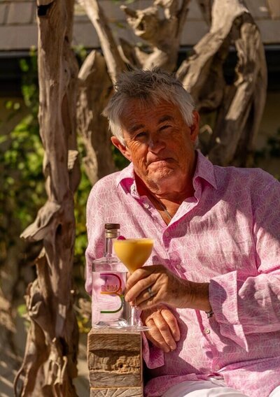 Kevin 'Snooky' Snook, drinking a rum cocktail sat outside in the sun and wearing a pink shirt