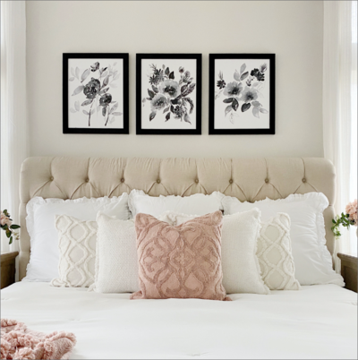 Bedroom space featuring MTH wall art above bed