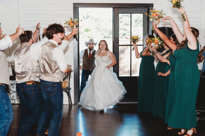 Lacey Nicole Photography at The Rosewood Venue in Mount Vernon Texas Bride and Groom Grand Entrance at wedding reception with wedding party