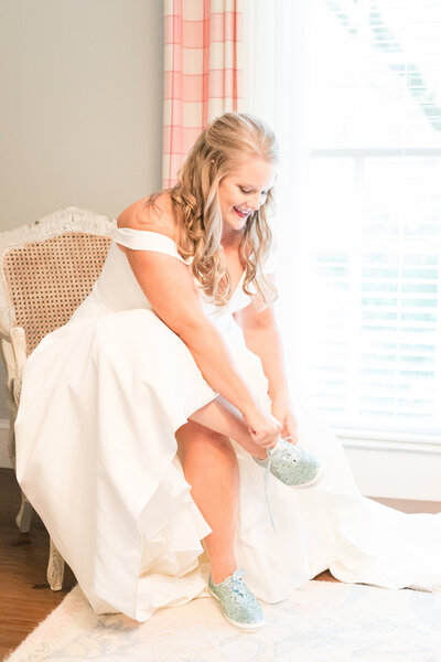 A bride finishes getting ready before her wedding, by Jennifer Marie Studios, Atlanta Georgia light and airy wedding photographer.
